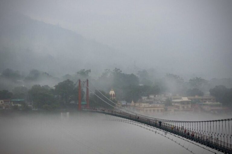 Foggy view of Ram Jhula bridge in Rishikesh from Sivananda Ashram side
