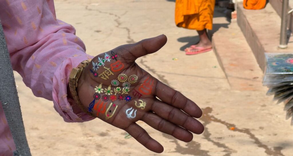 Sacred tilak symbols painted on a hand